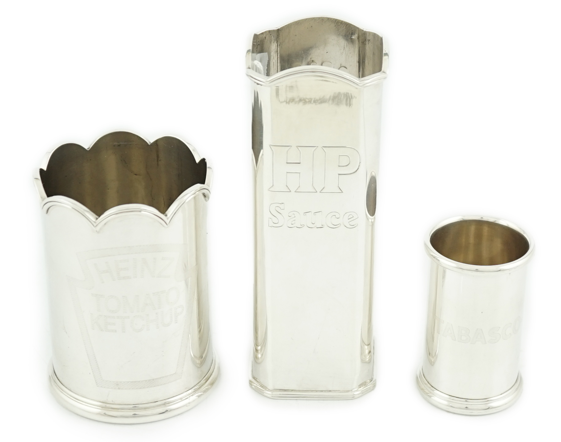 Three assorted Elizabeth II Theo Fennell silver bottle holders